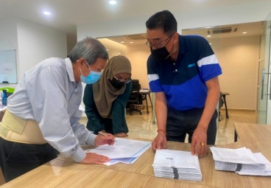 Staff reviewing documents during an ISO surveillance audit